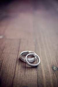two wedding rings on wooden floor