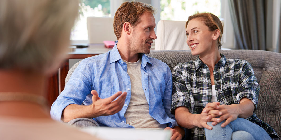 man and some talking while sitting on a couch